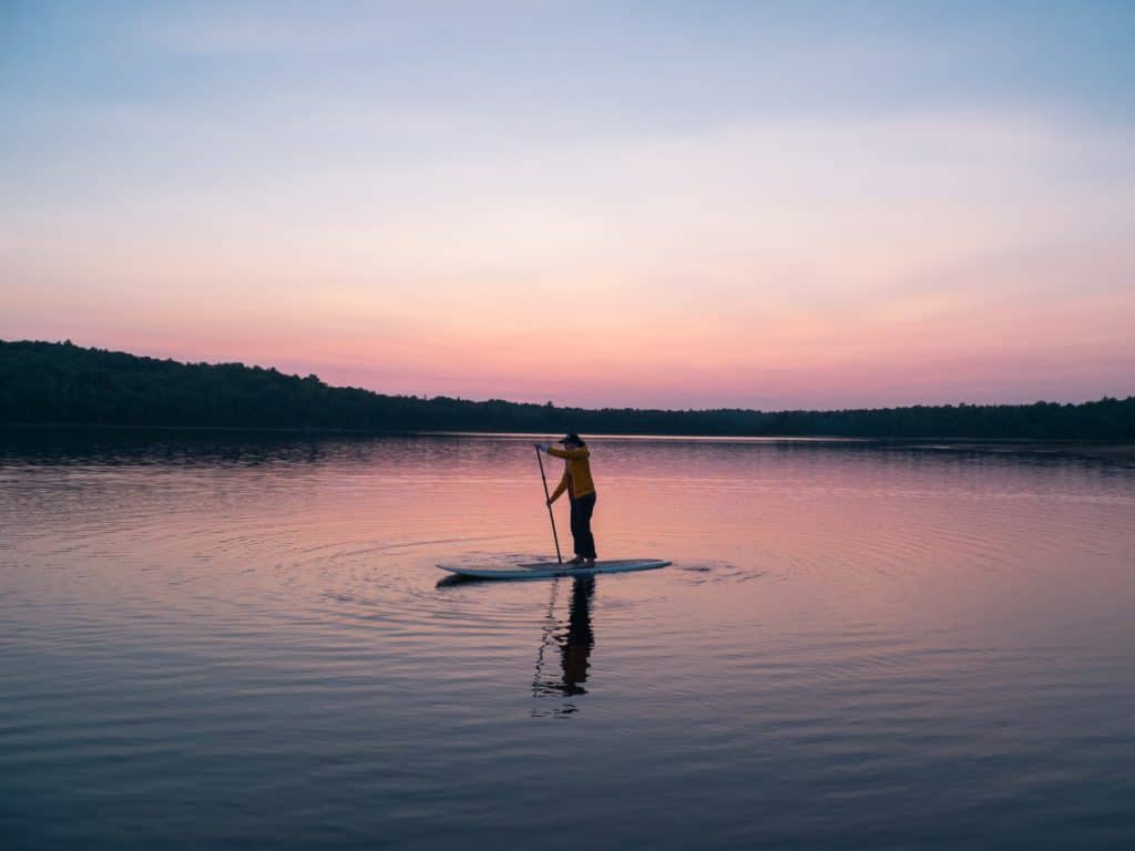 paddle boarder using an inflatable stand up paddleboard