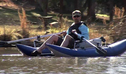 fisherman steering a highly rated inflatable pontoon boat for fishing